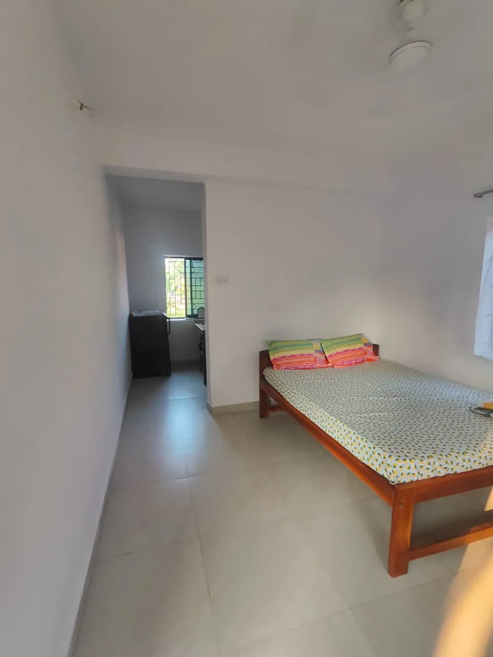 Student room at Alpesh Yoga with a double bed and a private entrance hallway